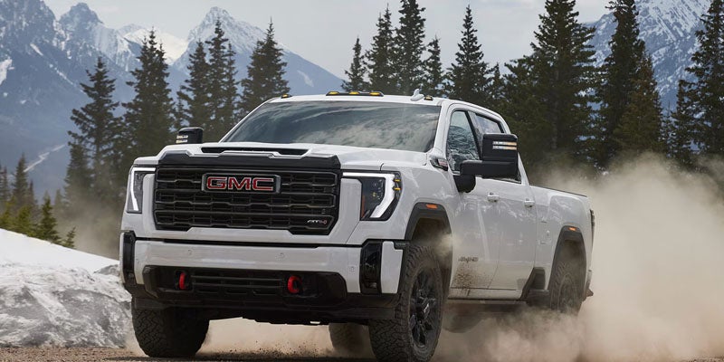 2026 GMC Sierra 2500 towing heavy equipment.